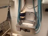 a sink with a hose attached to it in a bathroom