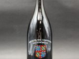 a bottle of red wine with a crest on it