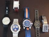a lot of watches that are sitting on a table