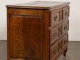 an old wooden chest of drawers on a wooden floor