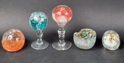 six different colored glass vases sitting on top of a black surface