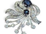 une photo d'une broche en noir et blanc sertie de diamants