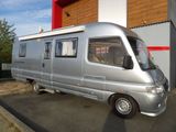 a silver van that is parked in front of a building
