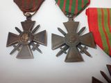 two medals are sitting on a table with ribbons around them