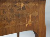 a close up of a wooden table with a drawer underneath it