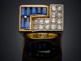 a yellow gold ring with blue sapphires and diamonds