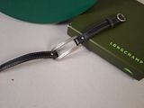 a green box with a black leather strap and a green box with a black leather strap