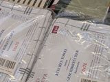 several packages of mail sitting on top of each other on top of a table