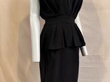 a picture of a black dress on a mannequin stand