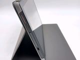 a close up of a laptop on a white surface