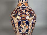 a vase with a design on it sitting on a table