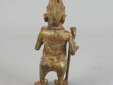 figurine of a man holding a stick and a stick in his hand