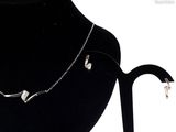 necklace and earring set on a mannequin display stand