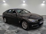 the bmw 3 series sedan is parked on a checkered tile floor
