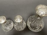 three glass bottles that are sitting on a table