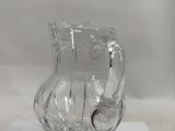 a clear glass pitcher sitting on a piece of paper