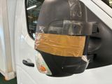 a white van with a brown tape on it ' s side mirror