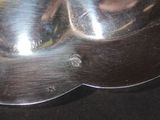 a silver plate with a banana in it on a table
