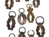 twelve bronze key chains with dragon heads and leaves on them