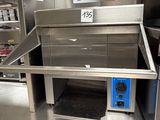 a stainless steel oven with a blue door in the middle of a kitchen