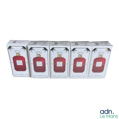 four boxes of perfumes are lined up on a white surface