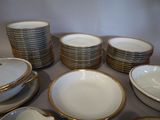 a lot of plates and bowls sitting on a table