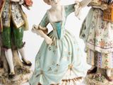 three figurines of people standing next to each other