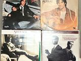many different album covers on the table