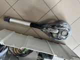 a tennis racket sitting on top of a sink in a bathroom