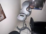 a chair and a stool in a room with a poster on the wall