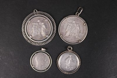 three silver pendants with a picture of jesus and mary on them