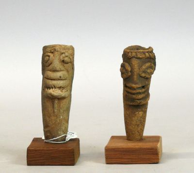 Deux têtes en terre cuite rosée au cou en pointe, aux larges…