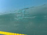 a green train with yellow stripes on the side of it