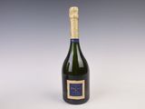 an empty bottle of champagne on a white surface