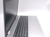 a silver laptop with a black keyboard on a white surface