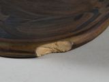 a wooden bowl with a hole in the middle of it