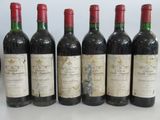 six bottles of wine are lined up in a row on a table