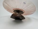 a white plate with a brown base on a white table