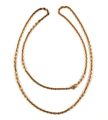 a close up of a gold chain necklace on a white background