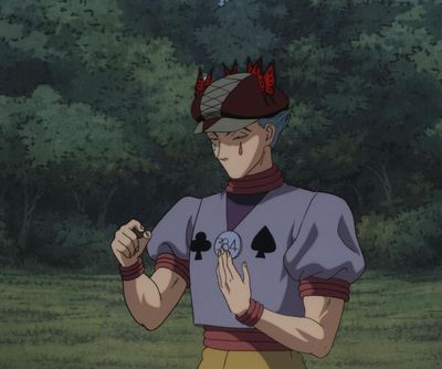 a man that is standing in the grass with a hat on