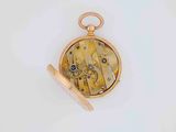 a gold pocket watch with a chain on a white surface