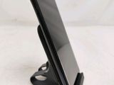 a cell phone that is on a stand on the table