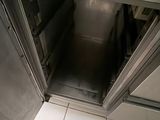 a person standing inside of a stainless steel oven
