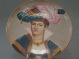a plate with a picture of a woman wearing a hat