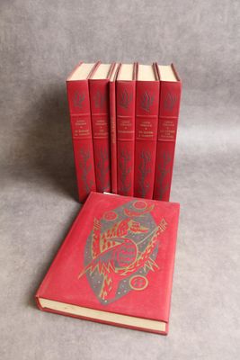 three red books sitting next to each other on a gray surface