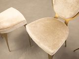 three chairs and a stool in a room