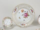 many different types of plates and bowls on the table