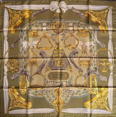 a square scarf with a gold and green design on it