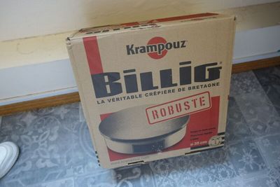 a box that is sitting on the floor next to a pair of shoes
