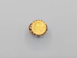 a gold ring with a coin in the middle of it